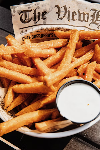 A plate with air-fried sweet potato fries and sauce.